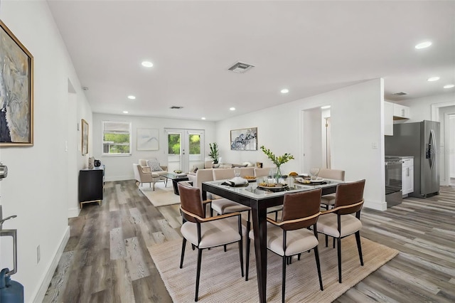dining space featuring wood finished floors, baseboards, and recessed lighting