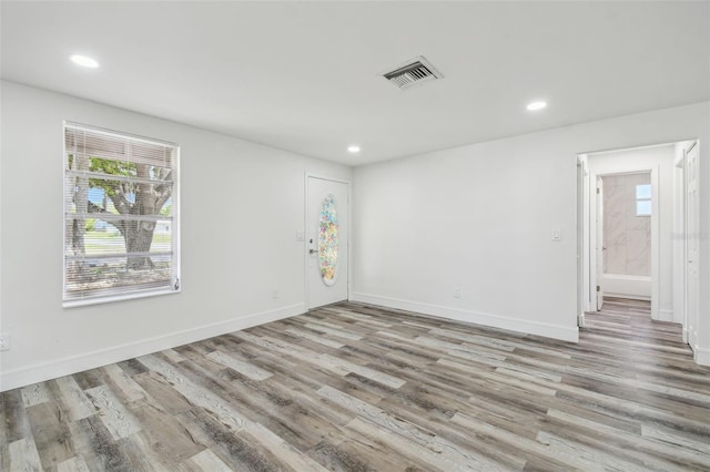 spare room with wood finished floors, recessed lighting, and baseboards