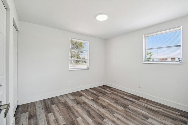 unfurnished bedroom with wood finished floors and baseboards