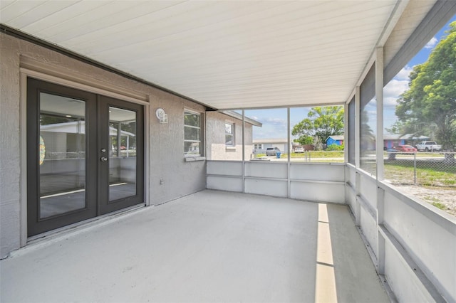 unfurnished sunroom with french doors