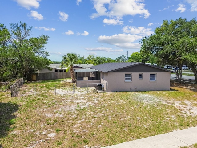 back of property featuring central air condition unit and a sunroom