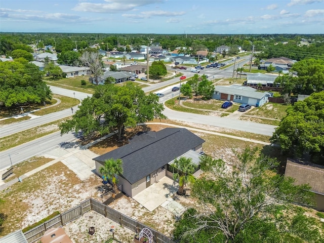 aerial view of residential area featuring a tree filled landscape