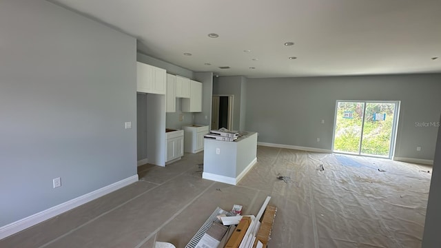 199 Statler St, Port Charlotte, FL 33954 - unfurnished living room featuring baseboards and recessed lighting