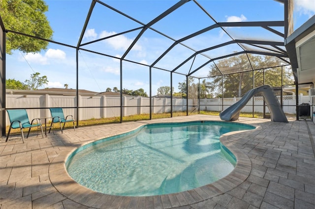view of swimming pool featuring a water slide, a patio, and a fenced backyard