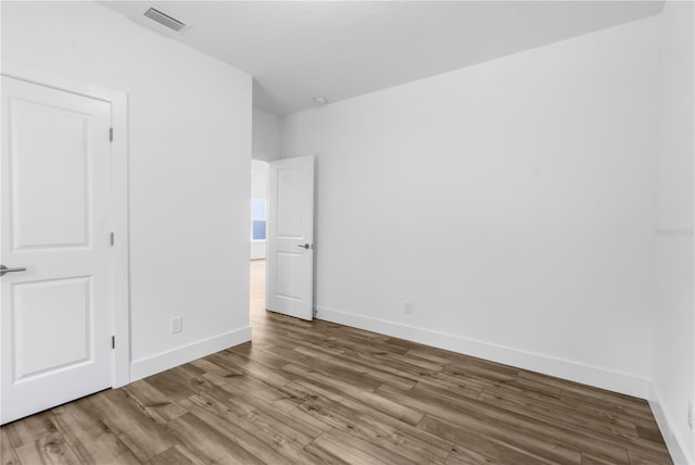 16247 Little Auk Rd, Weeki Wachee, FL 34614 - unfurnished bedroom with wood finished floors and baseboards