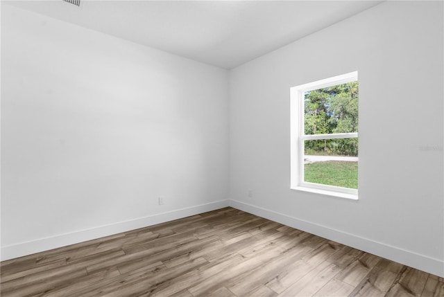 16247 Little Auk Rd, Weeki Wachee, FL 34614 - unfurnished room featuring wood finished floors and baseboards