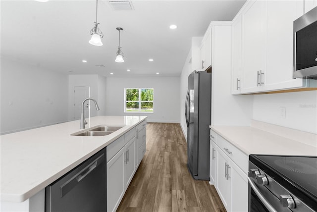 16247 Little Auk Rd, Weeki Wachee, FL 34614 - kitchen featuring stainless steel appliances, a sink, wood finished floors, light countertops, and recessed lighting