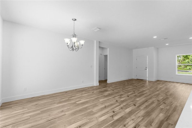 16247 Little Auk Rd, Weeki Wachee, FL 34614 - unfurnished room with a chandelier, recessed lighting, light wood-style floors, and baseboards