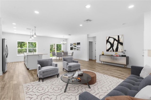 16247 Little Auk Rd, Weeki Wachee, FL 34614 - living area featuring light wood finished floors, a chandelier, recessed lighting, and baseboards