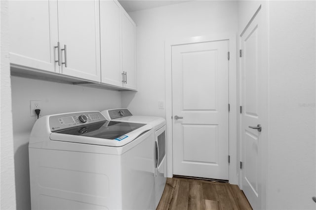 16247 Little Auk Rd, Weeki Wachee, FL 34614 - washroom featuring cabinet space, separate washer and dryer, and dark wood-type flooring