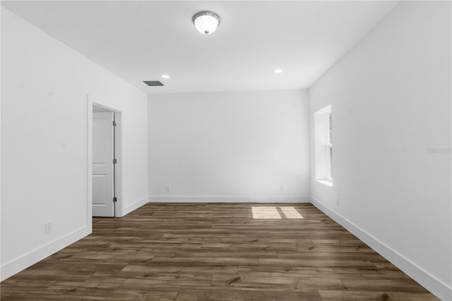 16247 Little Auk Rd, Weeki Wachee, FL 34614 - empty room with dark wood finished floors, recessed lighting, and baseboards