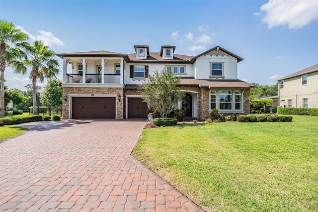 17724 Daisy Farm Dr, Lutz, FL 33559 - view of front facade featuring stone siding, stucco siding, decorative driveway, and an attached garage
