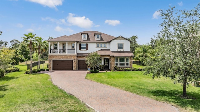 17724 Daisy Farm Dr, Lutz, FL 33559 - view of front facade featuring decorative driveway, an attached garage, a front yard, stone siding, and a balcony