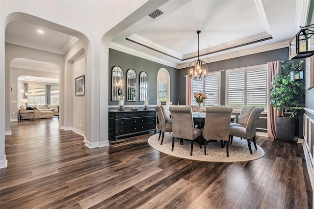 17724 Daisy Farm Dr, Lutz, FL 33559 - dining area with dark wood-style flooring, a chandelier, a raised ceiling, arched walkways, and ornamental molding