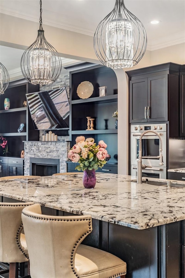 17724 Daisy Farm Dr, Lutz, FL 33559 - dining space featuring a chandelier, ornamental molding, a fireplace, and built in shelves