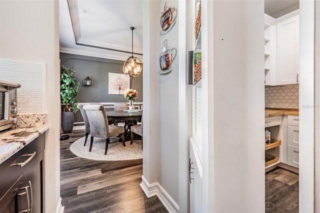 17724 Daisy Farm Dr, Lutz, FL 33559 - hallway featuring dark wood finished floors and a chandelier