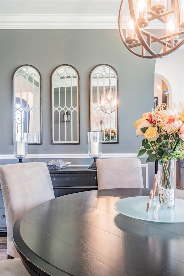 17724 Daisy Farm Dr, Lutz, FL 33559 - dining space featuring a chandelier, ornamental molding, healthy amount of natural light, and arched walkways