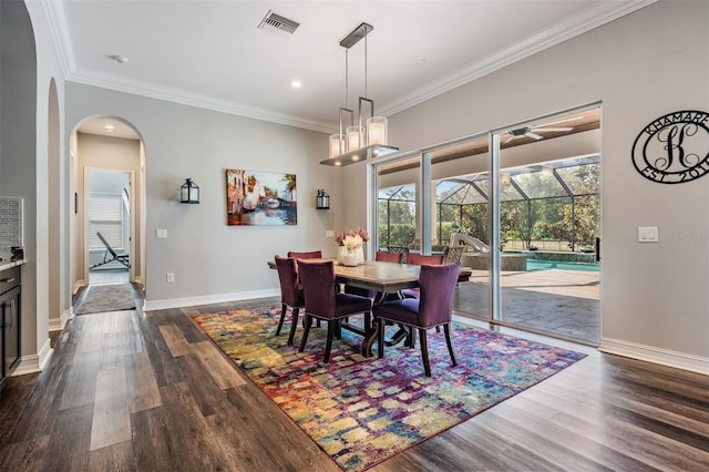 17724 Daisy Farm Dr, Lutz, FL 33559 - dining area with ornamental molding, dark wood-style flooring, a ceiling fan, arched walkways, and recessed lighting