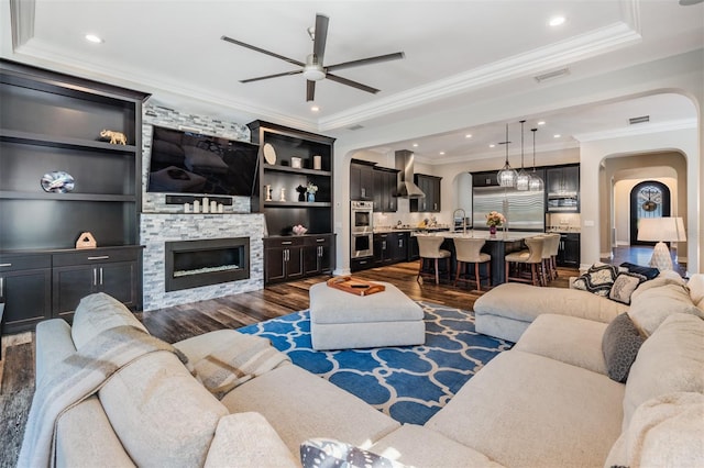 17724 Daisy Farm Dr, Lutz, FL 33559 - living room featuring arched walkways, a ceiling fan, dark wood-type flooring, crown molding, and recessed lighting