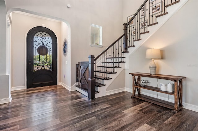 17724 Daisy Farm Dr, Lutz, FL 33559 - foyer featuring wood finished floors, arched walkways, stairs, and a towering ceiling