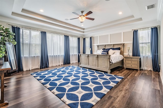 17724 Daisy Farm Dr, Lutz, FL 33559 - bedroom with a tray ceiling, wood finished floors, and a ceiling fan