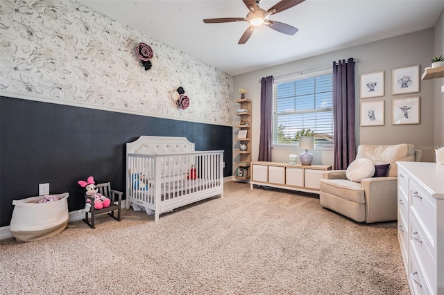 17724 Daisy Farm Dr, Lutz, FL 33559 - bedroom featuring wallpapered walls, a nursery area, light colored carpet, wainscoting, and a ceiling fan