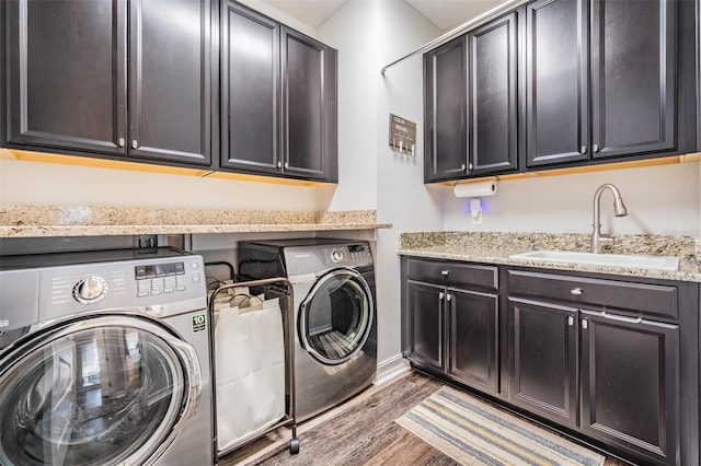 17724 Daisy Farm Dr, Lutz, FL 33559 - washroom with independent washer and dryer, cabinet space, and light wood-style flooring