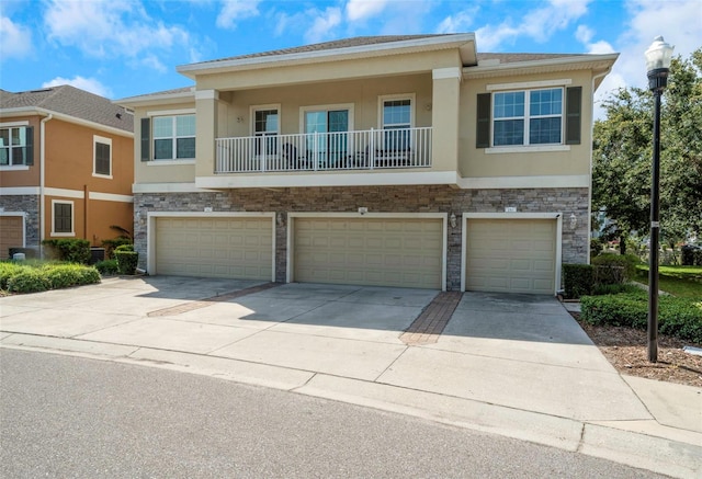 7001 Interbay Blvd Unit 242, Tampa, FL 33616 - multi unit property with concrete driveway, stucco siding, a garage, and stone siding