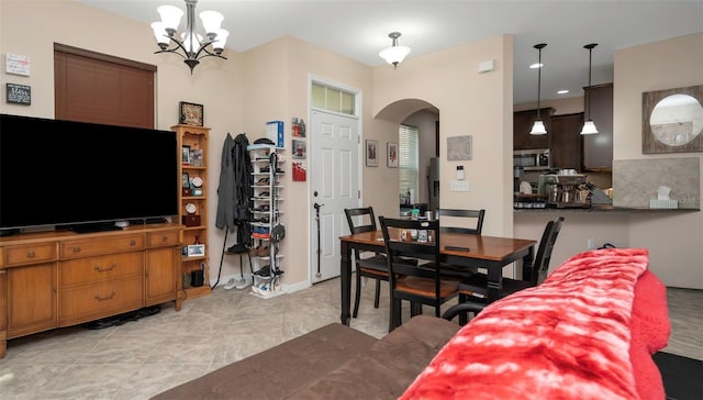 7001 Interbay Blvd Unit 242, Tampa, FL 33616 - dining room featuring arched walkways and a chandelier