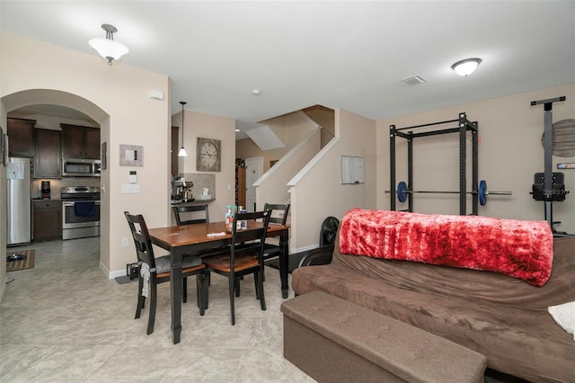 7001 Interbay Blvd Unit 242, Tampa, FL 33616 - dining space featuring arched walkways, stairs, and baseboards