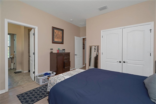 7001 Interbay Blvd Unit 242, Tampa, FL 33616 - bedroom with light wood finished floors, baseboards, and a closet
