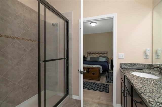 7001 Interbay Blvd Unit 242, Tampa, FL 33616 - ensuite bathroom featuring a stall shower, vanity, and tile patterned flooring