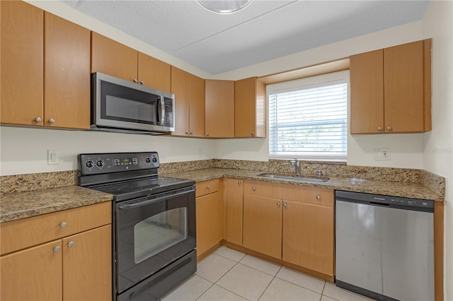 2820 Somerset Park Dr Unit 101, Tampa, FL 33613 - kitchen featuring stainless steel appliances, a sink, light tile patterned floors, and light stone counters