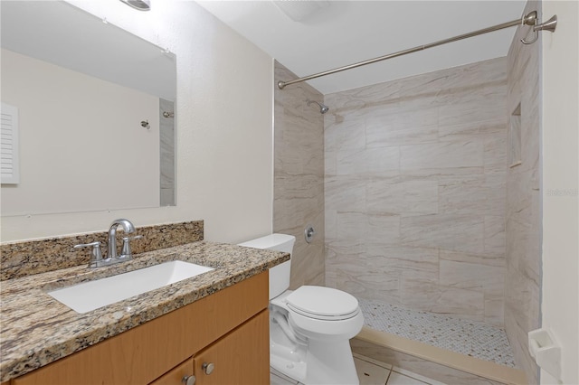 2820 Somerset Park Dr Unit 101, Tampa, FL 33613 - full bathroom with toilet, vanity, a tile shower, and tile patterned flooring