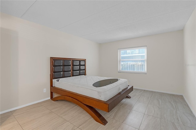 2820 Somerset Park Dr Unit 101, Tampa, FL 33613 - bedroom with baseboards and light tile patterned floors
