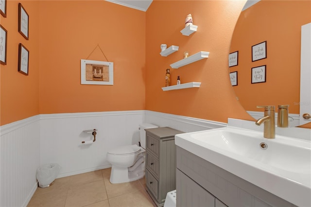 11684 Brighton Knoll Loop, Riverview, FL 33579 - bathroom featuring toilet, wainscoting, vanity, and tile patterned flooring