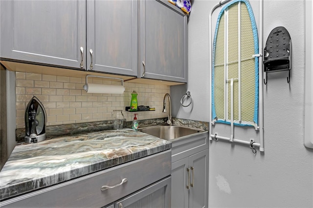 11684 Brighton Knoll Loop, Riverview, FL 33579 - kitchen with gray cabinetry, a sink, and tasteful backsplash