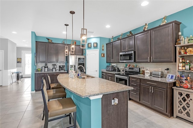 11684 Brighton Knoll Loop, Riverview, FL 33579 - kitchen with stainless steel appliances, a sink, dark brown cabinets, and recessed lighting