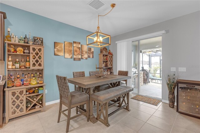 11684 Brighton Knoll Loop, Riverview, FL 33579 - dining space featuring wine cooler, a chandelier, light tile patterned flooring, and baseboards