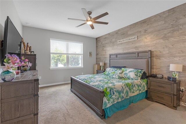 11684 Brighton Knoll Loop, Riverview, FL 33579 - bedroom with an accent wall, light carpet, baseboards, a ceiling fan, and wood walls