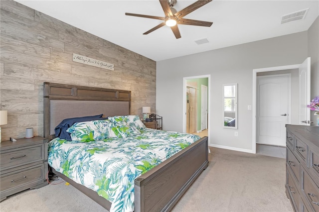 11684 Brighton Knoll Loop, Riverview, FL 33579 - bedroom featuring an accent wall, baseboards, light carpet, wooden walls, and ceiling fan