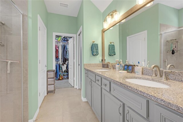 11684 Brighton Knoll Loop, Riverview, FL 33579 - full bath with double vanity, a stall shower, a walk in closet, and tile patterned flooring