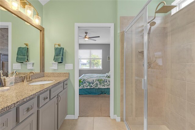 11684 Brighton Knoll Loop, Riverview, FL 33579 - ensuite bathroom with vanity, tile patterned floors, a stall shower, a ceiling fan, and baseboards