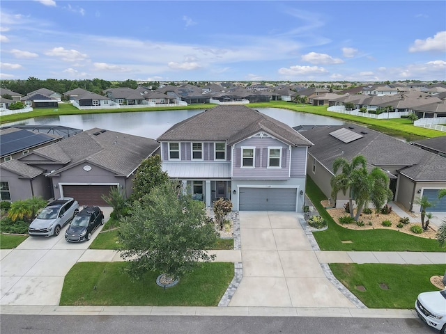 11684 Brighton Knoll Loop, Riverview, FL 33579 - view of front facade featuring a residential view, concrete driveway, a front yard, and a water view