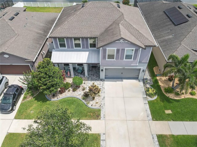 11684 Brighton Knoll Loop, Riverview, FL 33579 - view of front facade with a garage, roof with shingles, and concrete driveway