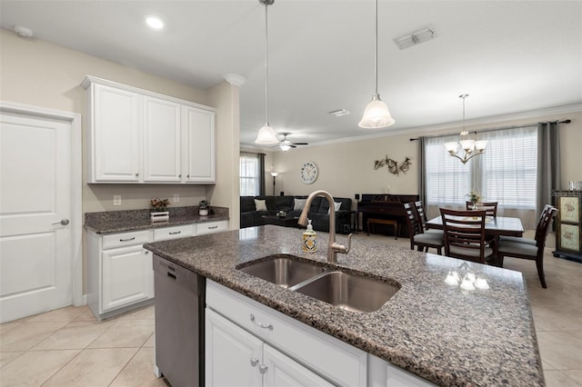 3972 Wisdom Trl, Land O Lakes, FL 34638 - kitchen featuring a sink, stainless steel dishwasher, light tile patterned floors, decorative light fixtures, and white cabinets