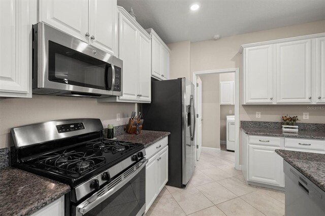 3972 Wisdom Trl, Land O Lakes, FL 34638 - kitchen featuring stainless steel appliances, white cabinetry, washer / dryer, and light tile patterned flooring