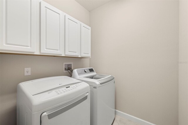 3972 Wisdom Trl, Land O Lakes, FL 34638 - laundry area with cabinet space, separate washer and dryer, baseboards, and light tile patterned flooring