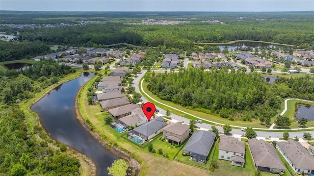3972 Wisdom Trl, Land O Lakes, FL 34638 - aerial view of property's location featuring a heavily wooded area, nearby suburban area, and a large body of water