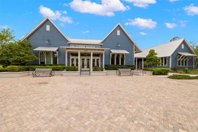 3972 Wisdom Trl, Land O Lakes, FL 34638 - back of property with french doors, a standing seam roof, and metal roof